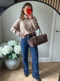 Knitted pale brown jumper with pearl and gold buttons on sleeve.