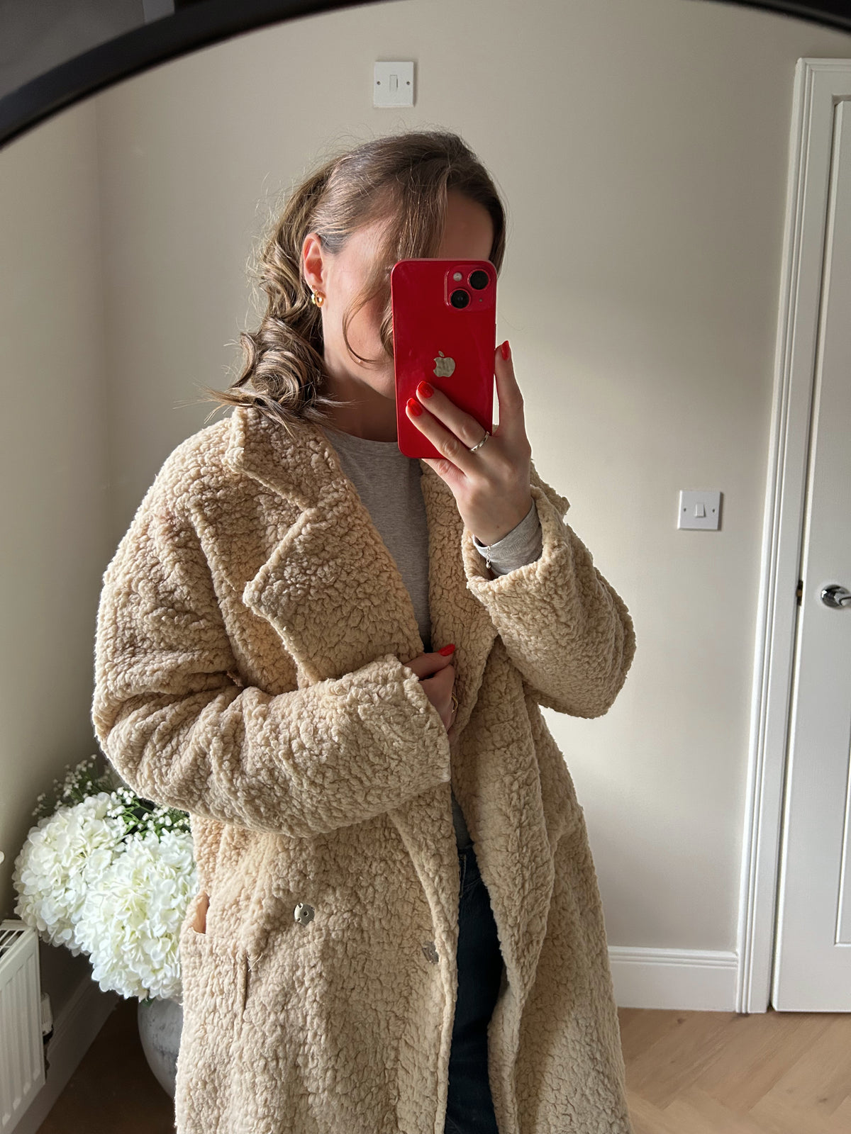 Biege sherpa coat close up with two outside pockets.