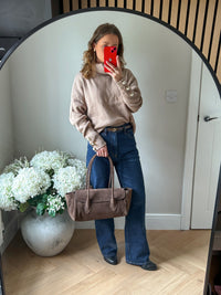 Slightly oversized beige roll neck jumper with pearl button detailing.