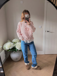 Loose fit pink knitted jumper with heart shaped pom pom detailing.