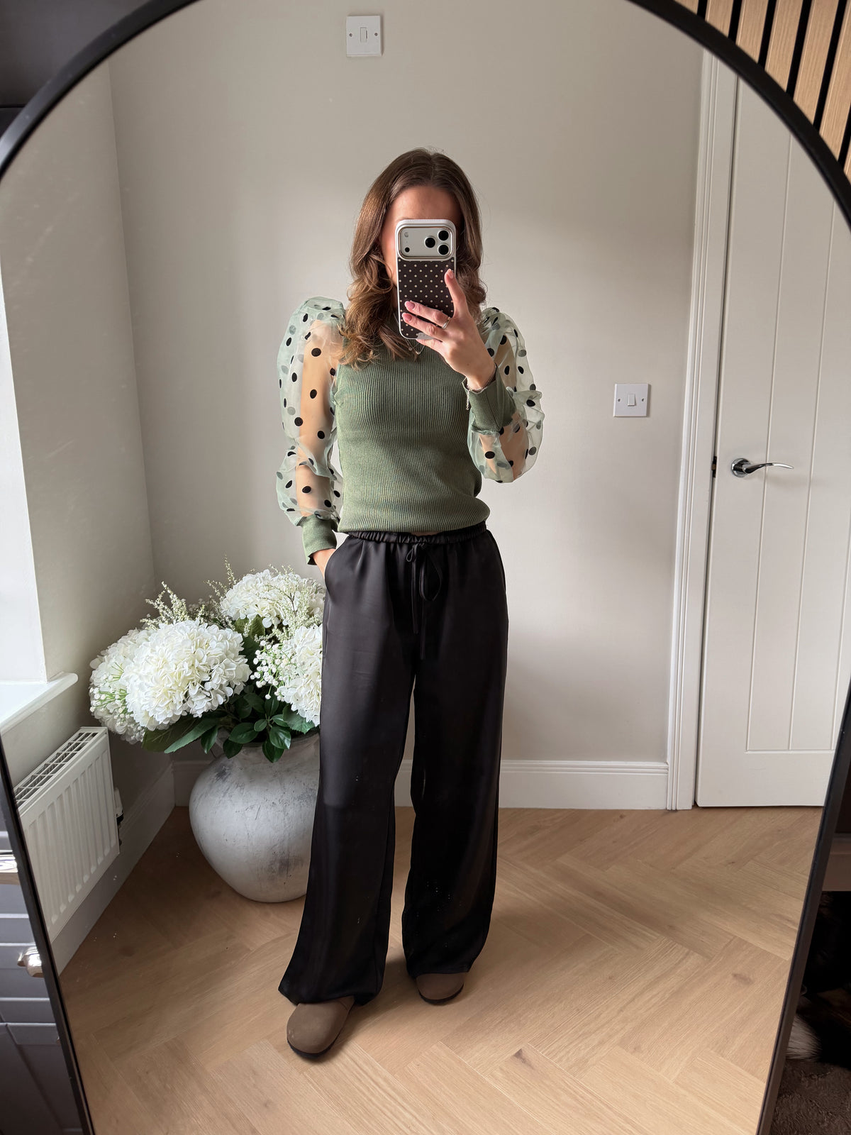 Khaki fine knit jumper with puff shoulder sleeves in a sheer material with polka dots.