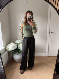Khaki fine knit jumper with puff shoulder sleeves in a sheer material with polka dots.