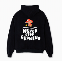 Positivity Hoodie with Never Stop Growing slogan with toadstool graphic